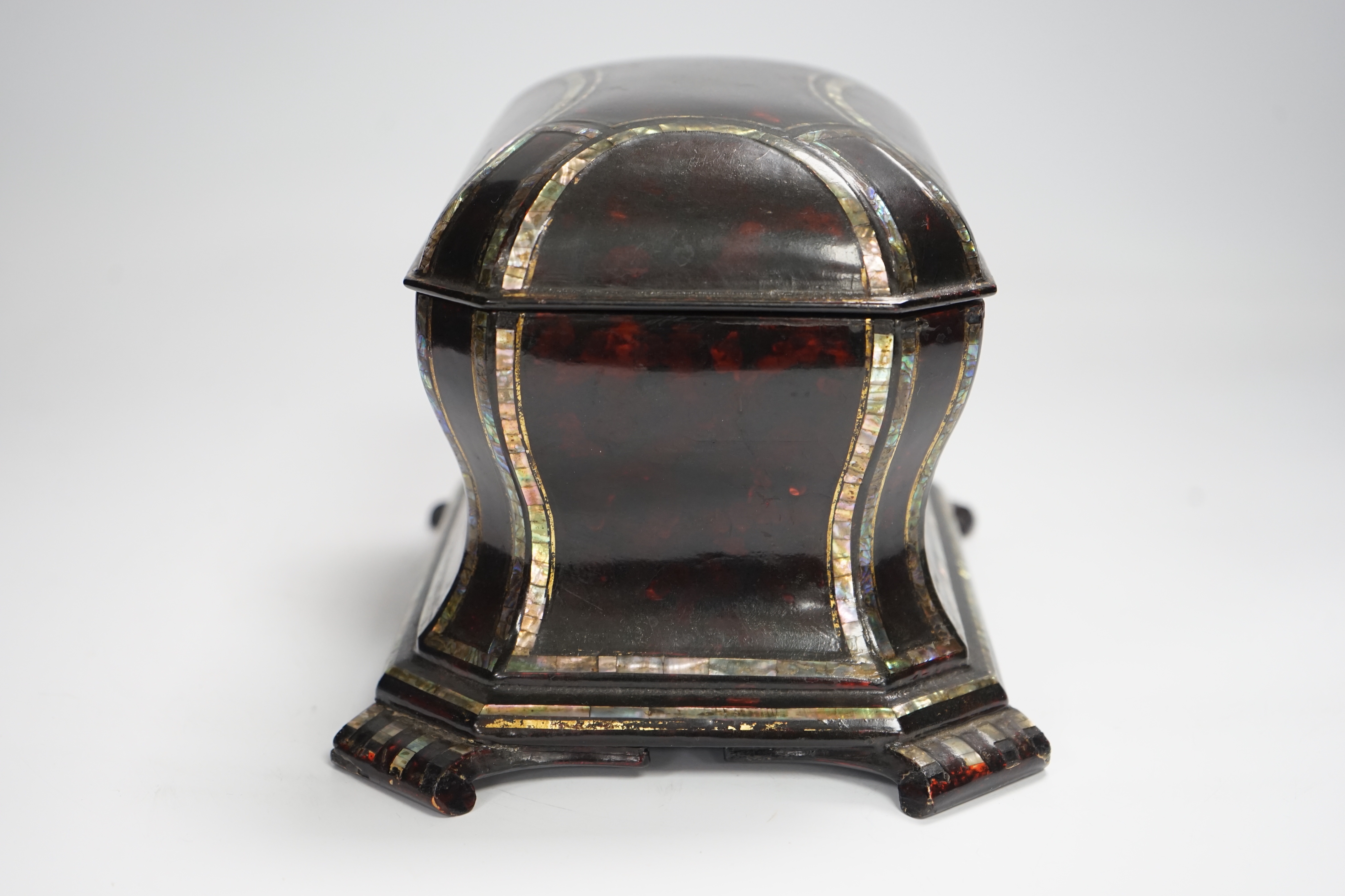 A Victorian papier mache tea caddy, stamped Jennens and Bettridge, in the form of a sarcophagus with inset mother of pearl banding, with two internal lidded compartments, 15cm high